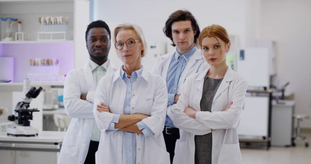 Multiracial team of scientists working together in a laboratory.
