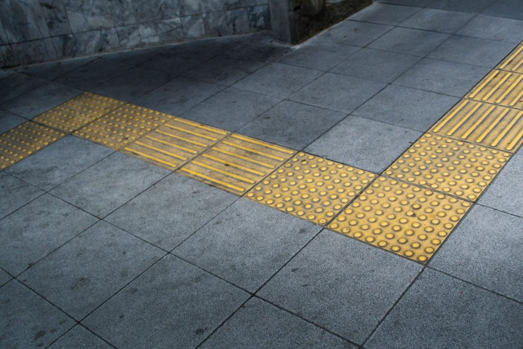 Tactile paving on footpath for people who are blind. 